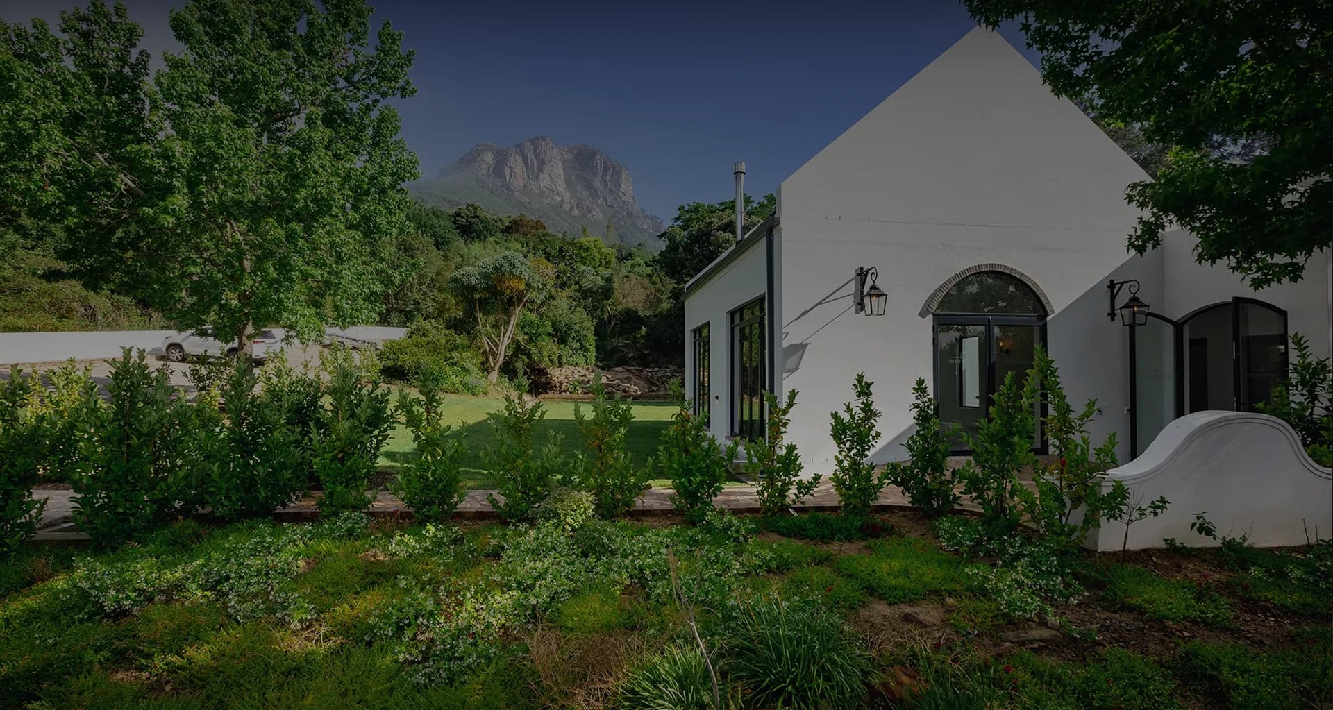 Cape Dutch guesthouse against the Banhoek Valley mountains