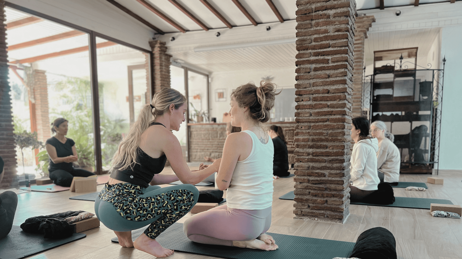 Skye Harrison teaching yoga at an event in Marbella