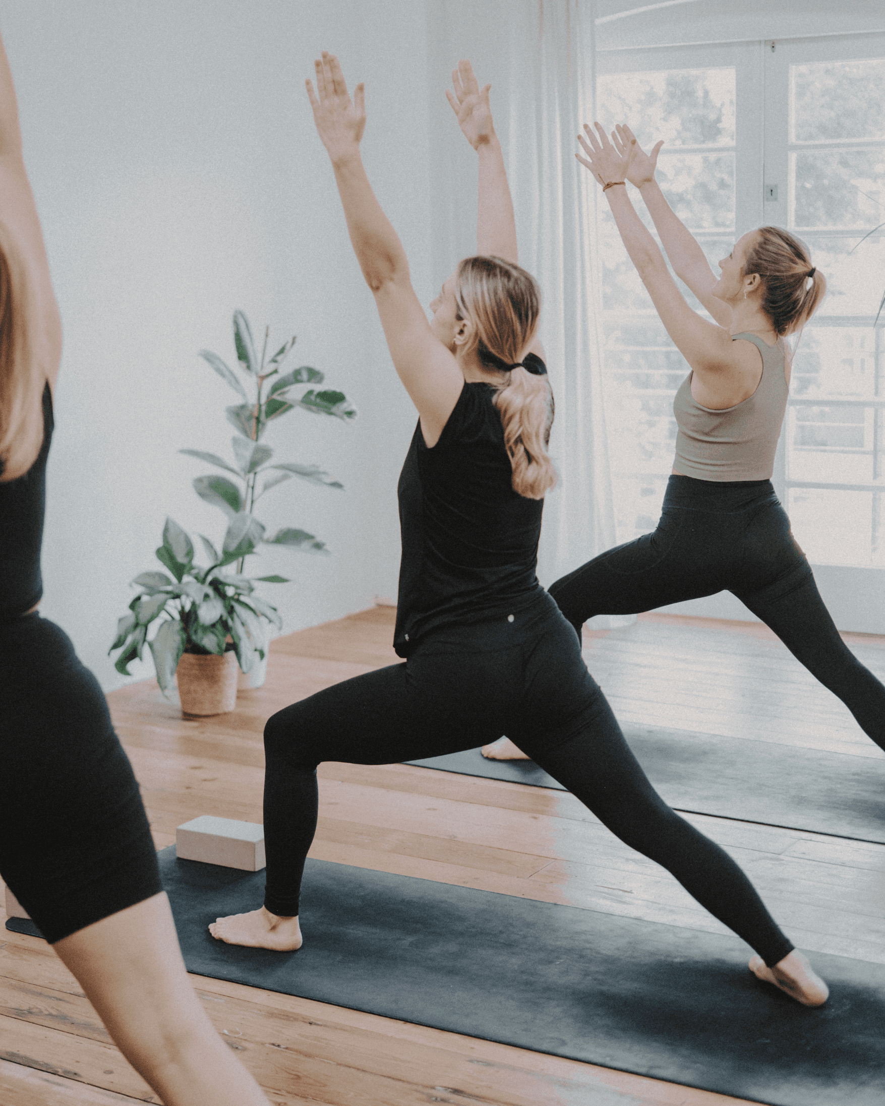 Skye guiding students through warrior 1 in a London studio