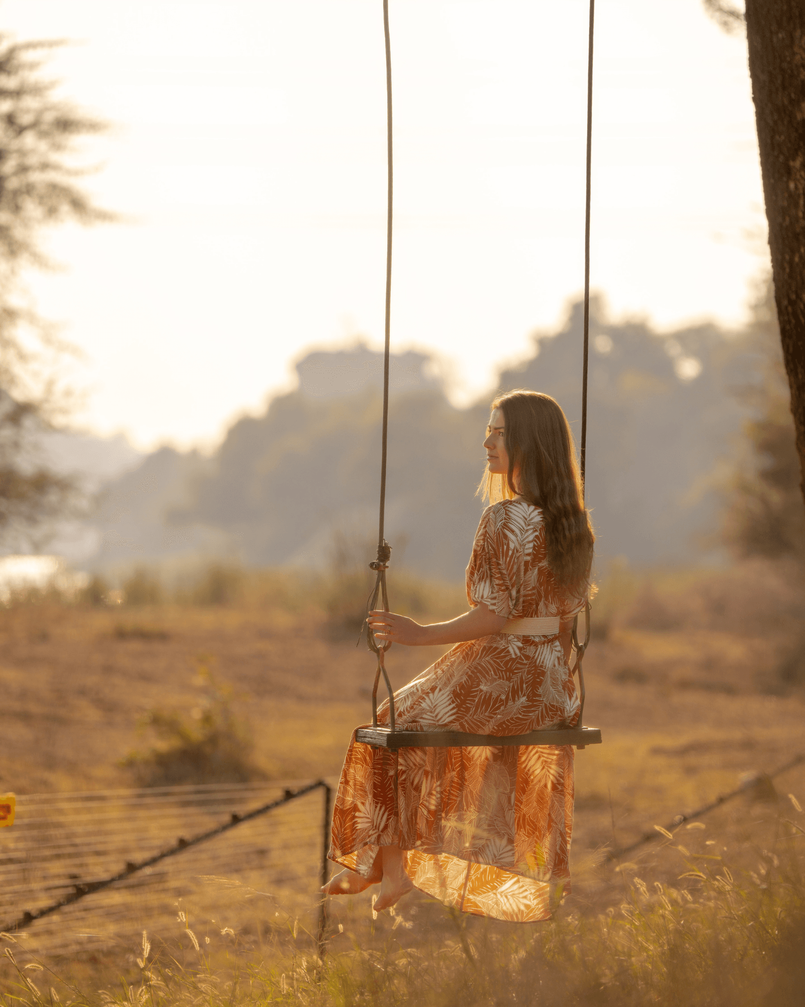 Lady on a swing watching nature in the South African bush