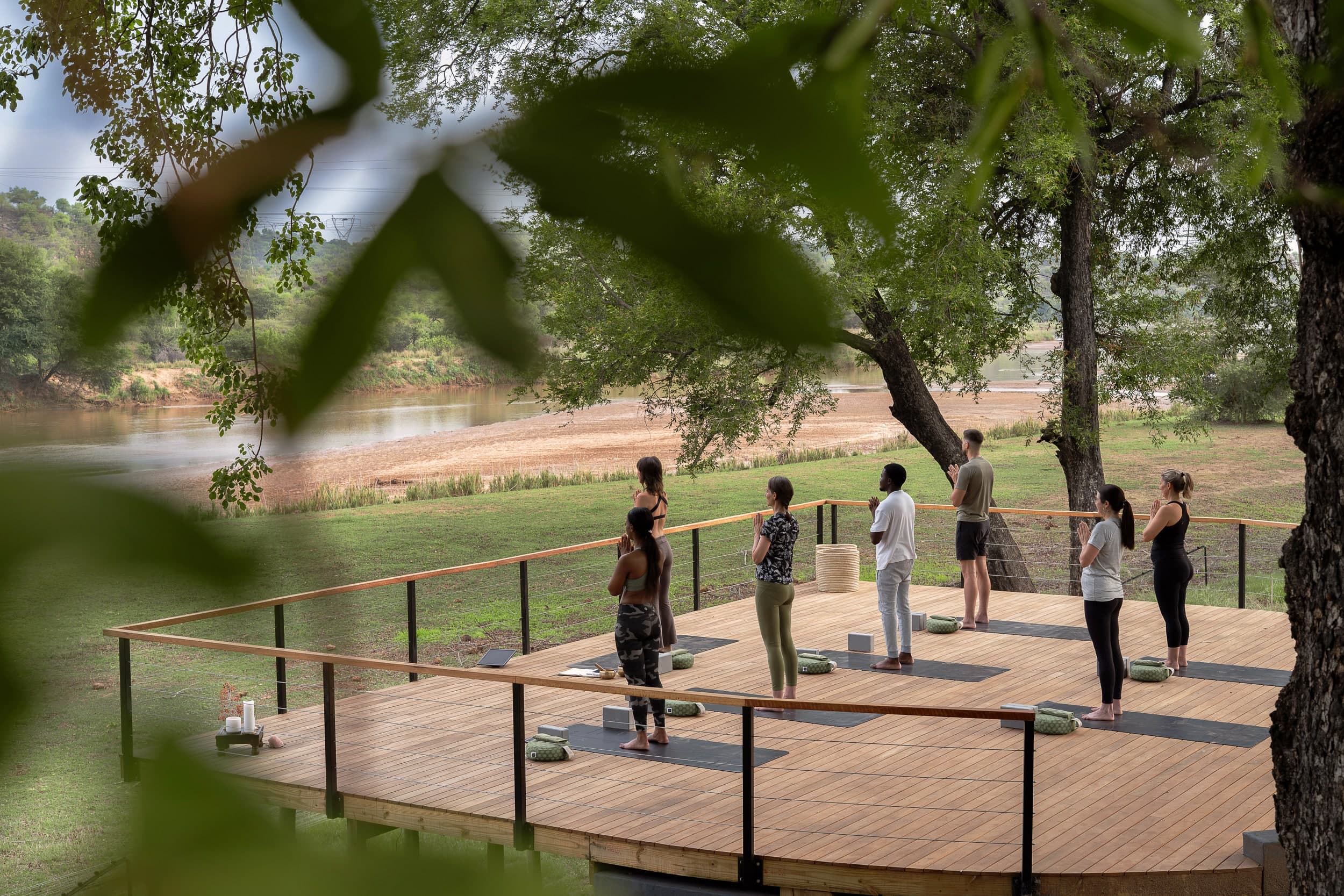 Morning yoga on the riverside deck at Sashwa